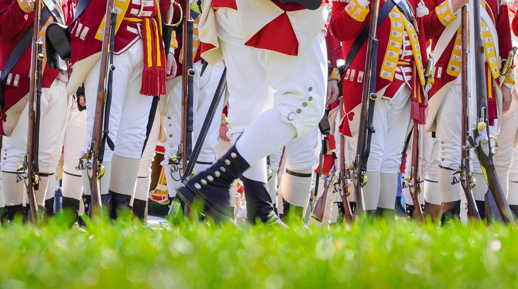 Legs of British soldiers of American revolutionary war on green battlefield in Lexington, MA