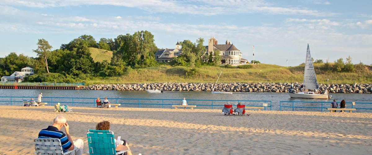Holland State Park featuring general coastal views and a beach as well as a couple