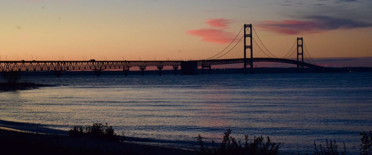 The Mackinac Bridge spans the Straits of Mackinac, connecting lower and upper Michigan. Lake Huron is in the foreground and Lake Michigan is in the background behind the bridge. I liked the patterns created by the bridge structure. #patterns #michigan #bridges #AquaTrove #blue #Nature