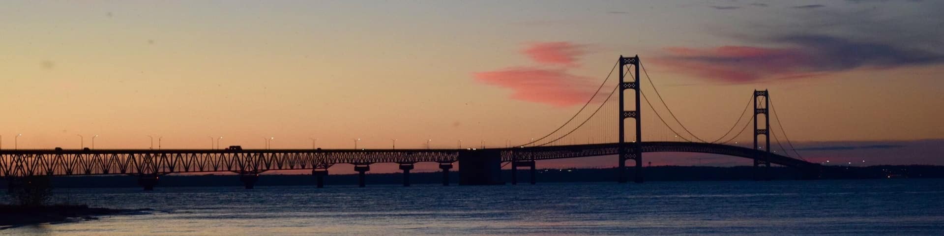 The Mackinac Bridge spans the Straits of Mackinac, connecting lower and upper Michigan. Lake Huron is in the foreground and Lake Michigan is in the background behind the bridge. I liked the patterns created by the bridge structure. #patterns #michigan #bridges #AquaTrove #blue #Nature