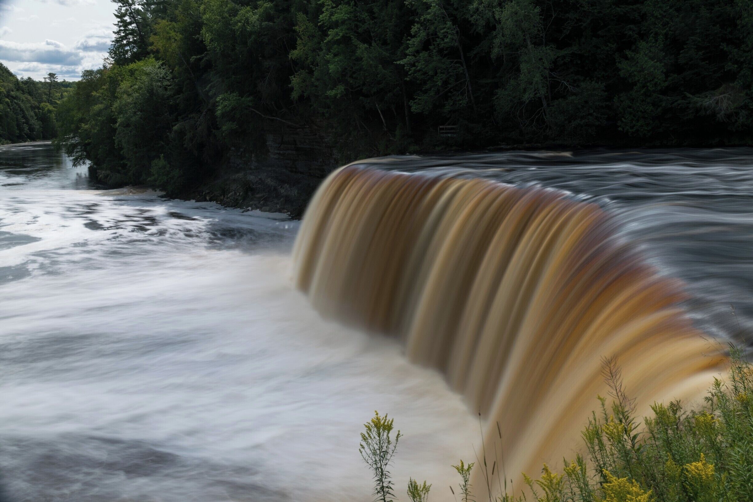 Classic Michigan Waterfall.  The Upper Tahquamenon Falls are easy to get to, with photo spots along the river.  Best in fall and  winter #River 