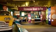 A museum exhibit with a yellow car, a purple banner reading 'Kalamazoo Direct to You', and various informational displays.