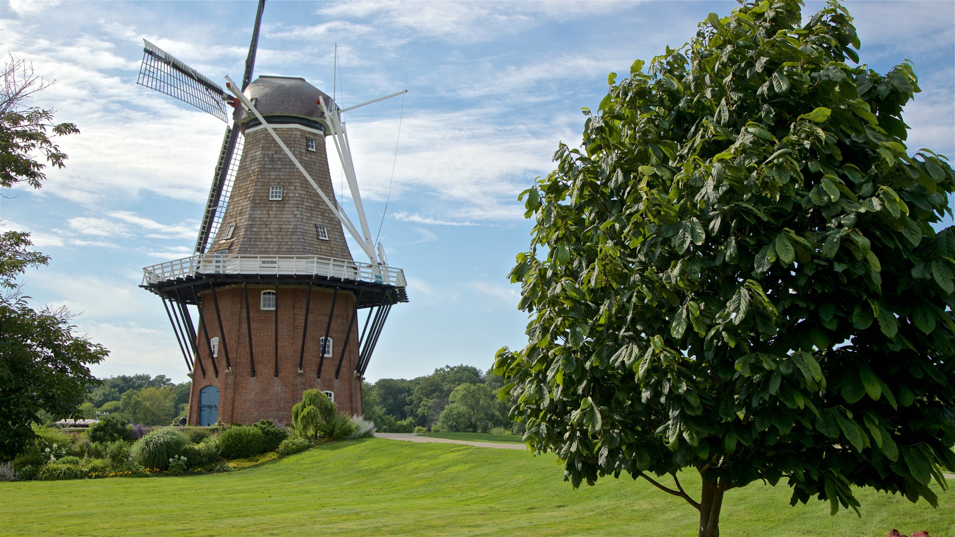 Windmill Island featuring a windmill and a garden