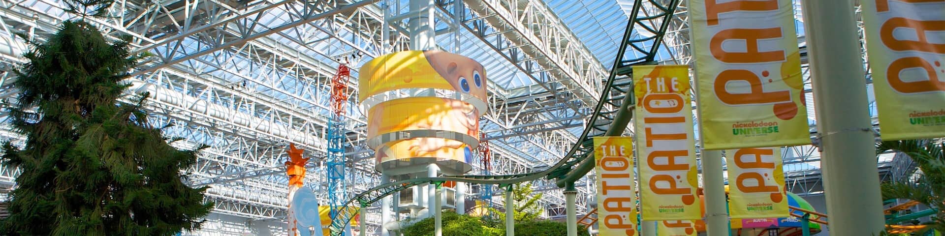 A colorful indoor amusement park with a large Ferris wheel, various rides, and a 'Blue's Skidoo' attraction.