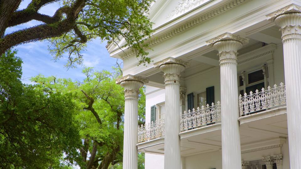 A white building with columns and a balcony.