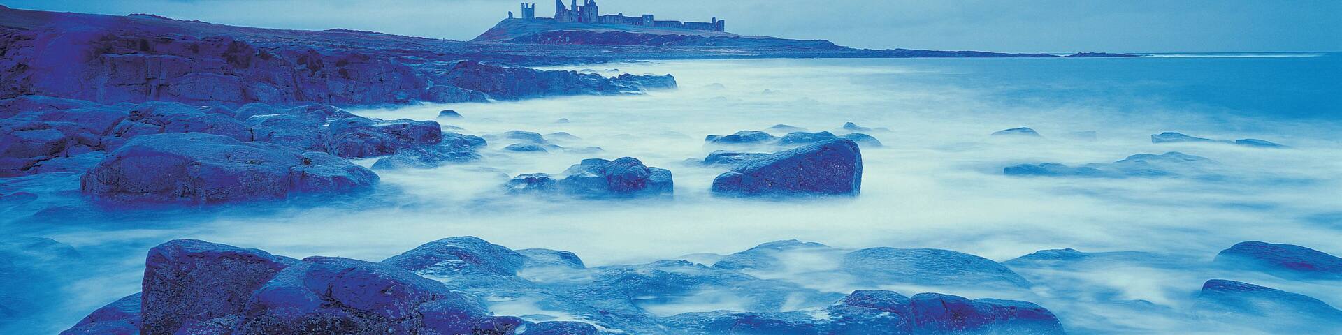 Gloomy coastline with distant castle