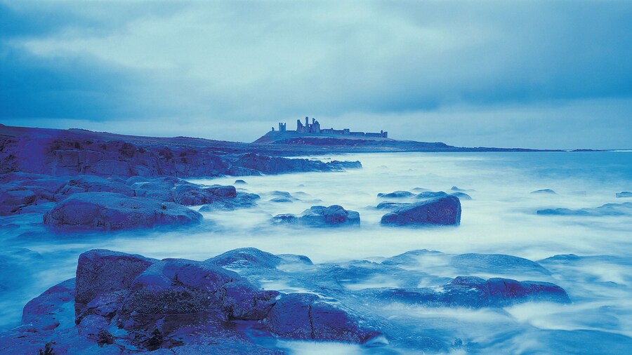 Gloomy coastline with distant castle
