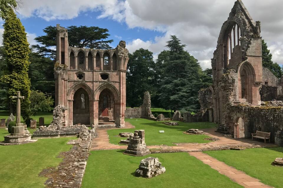 A historic church ruin with arched windows and a stone pathway.
