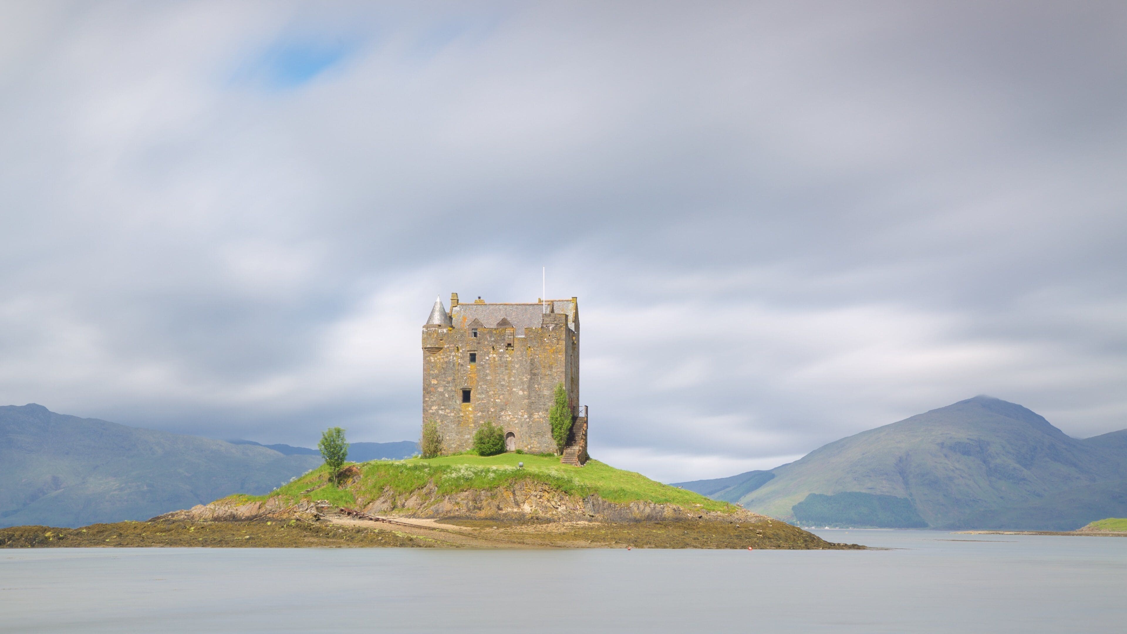 Castle Stalker showing heritage elements, a lake or waterhole and heritage architecture