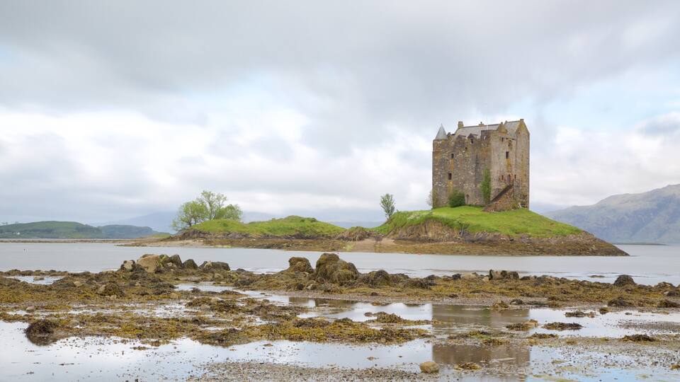 A historic castle on a small island surrounded by water.
