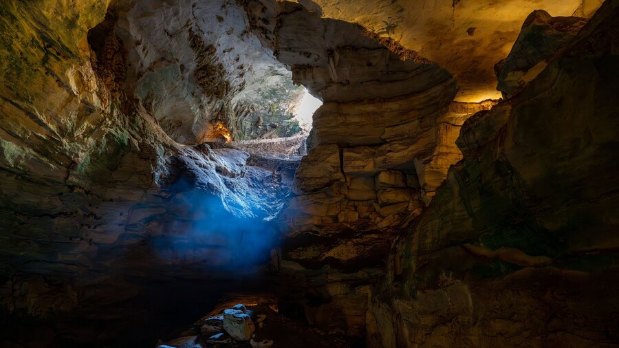Image depicts a view of Carlsbad Caverns in New Mexico, shrouded in an ethereal mist