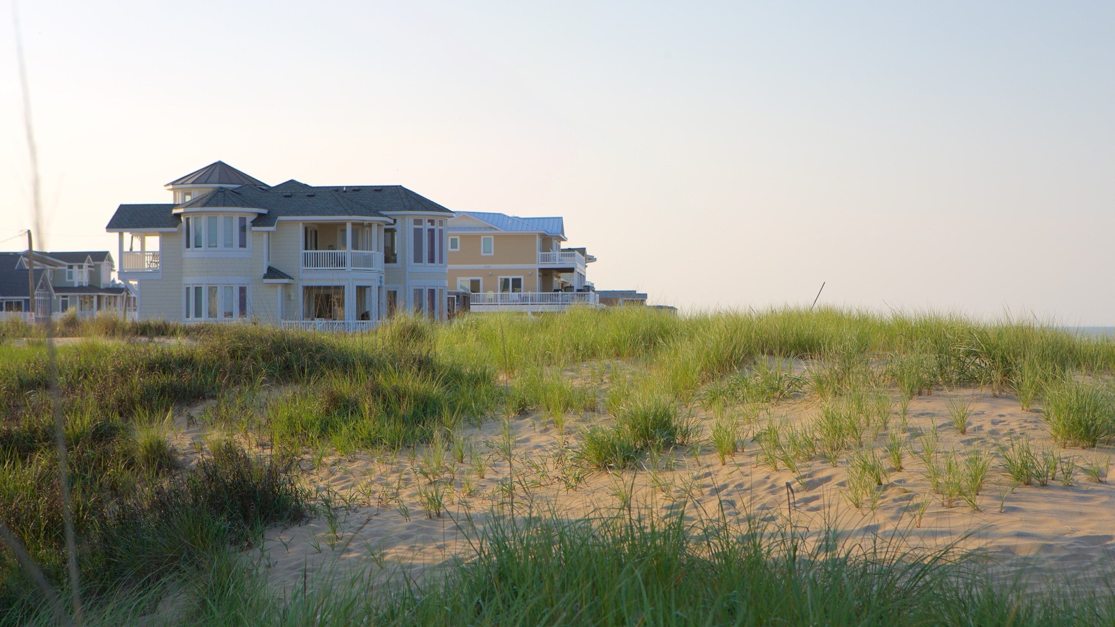 Sandbridge Beach which includes a house, a sandy beach and general coastal views