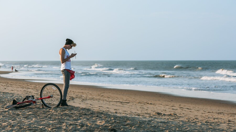 Sandbridge Beach showing a sandy beach and general coastal views as well as an individual male