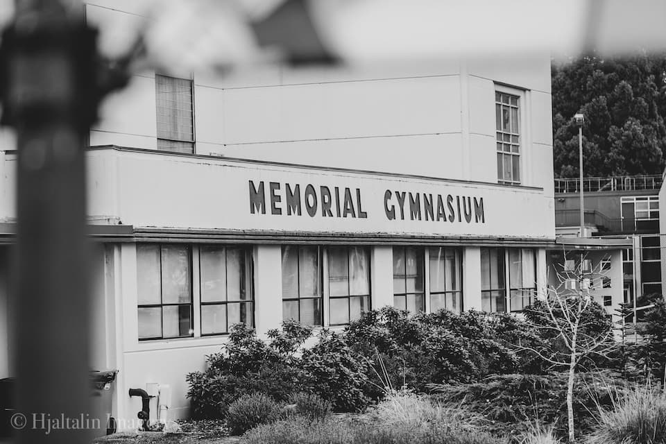 A building labeled "Memorial Gymnasium" with large windows and a flat roof.
