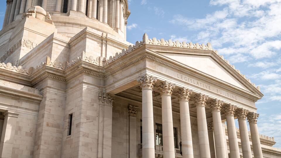 A neoclassical building with large columns and intricate carvings.