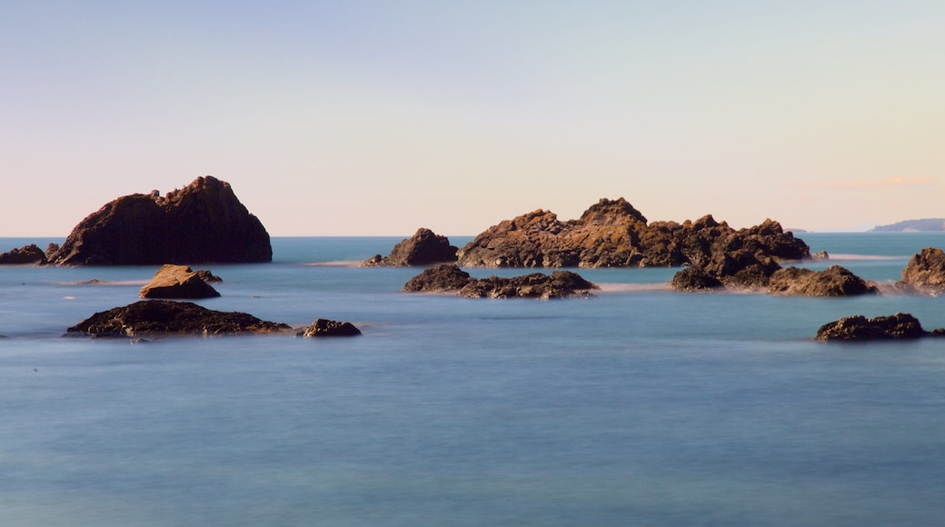 Deception Pass State Park showing a bay or harbor, rocky coastline and a sunset