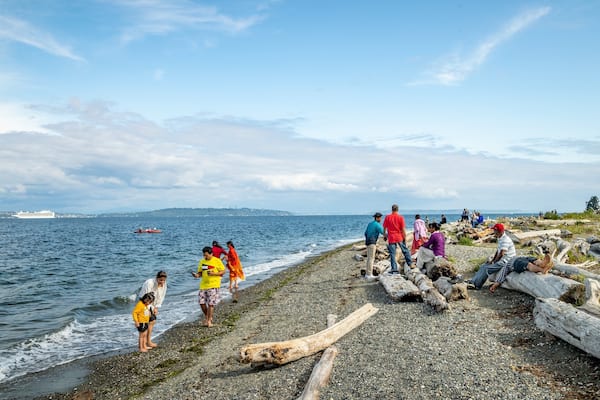 Fay Bainbridge State Park featuring general coastal views and a pebble beach as well as a small group of people