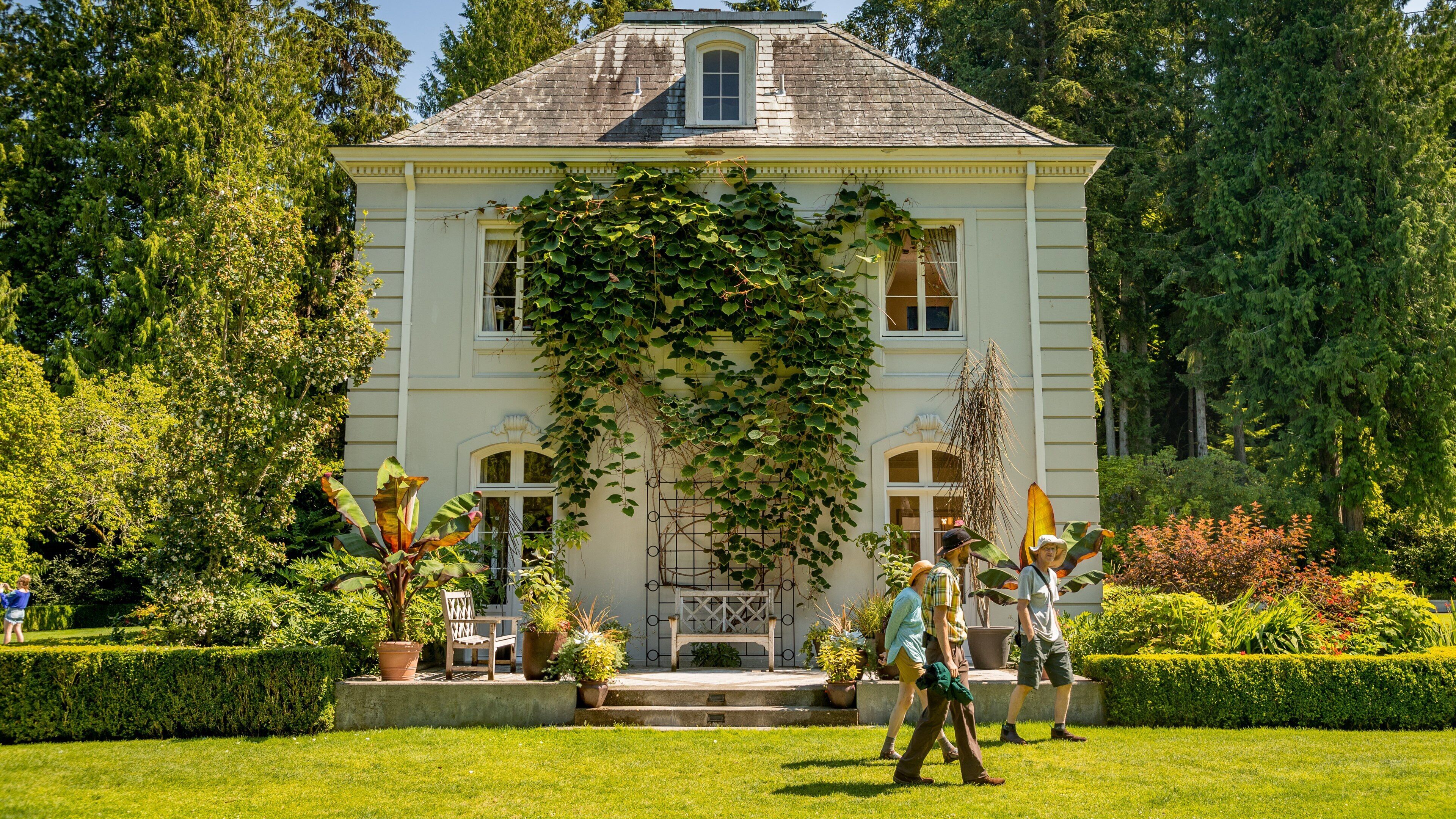 Bloedel Reserve featuring a garden and a house as well as a small group of people