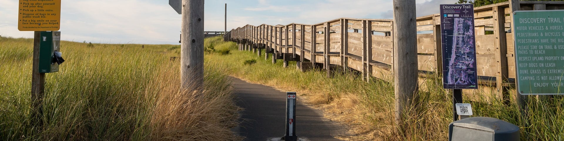 A wooden archway with the number 1805, a Discovery Trail sign, and a trash can.