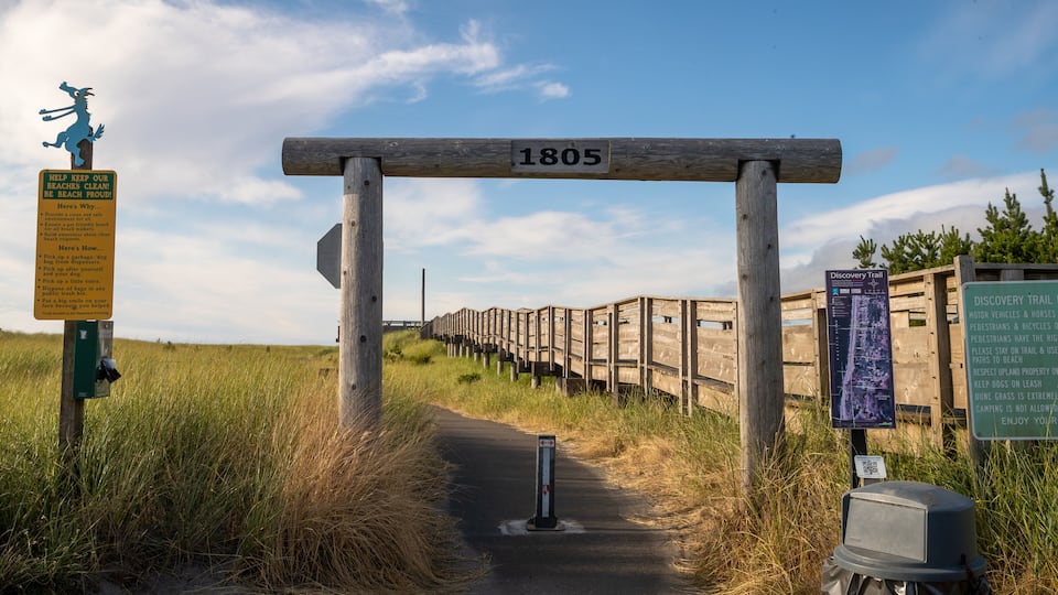 A wooden archway with the number 1805, a Discovery Trail sign, and a trash can.