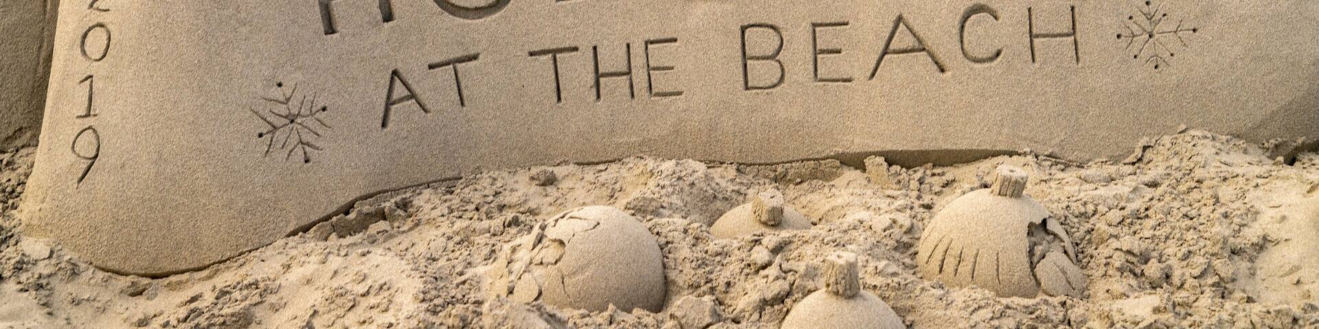 Long Beach featuring outdoor art, signage and a sandy beach