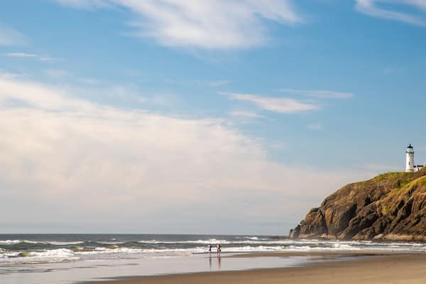 Cape Disappointment State Park which includes a beach, a sunset and a lighthouse