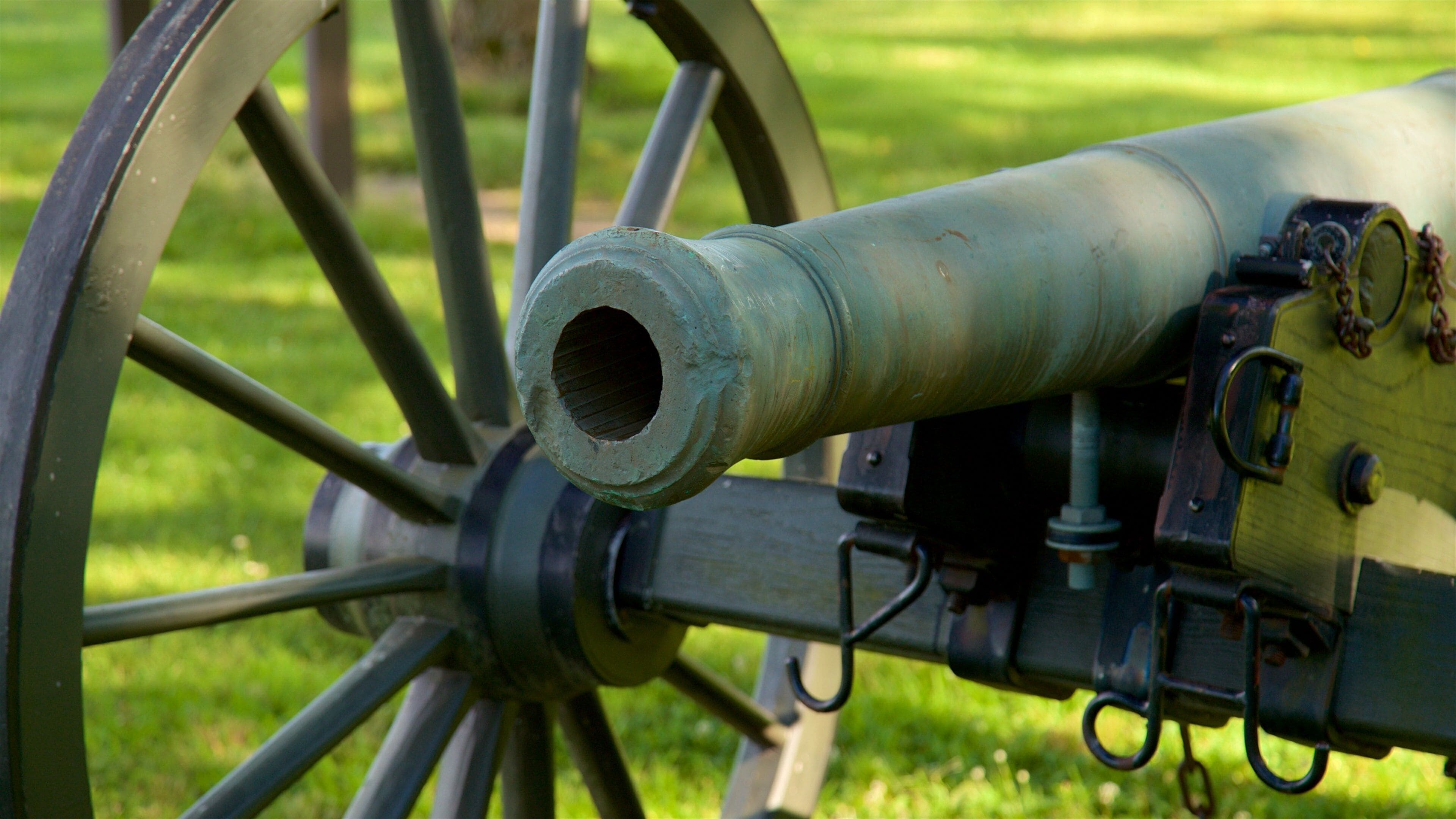 A cannon with a large wheel and a metal barrel.
