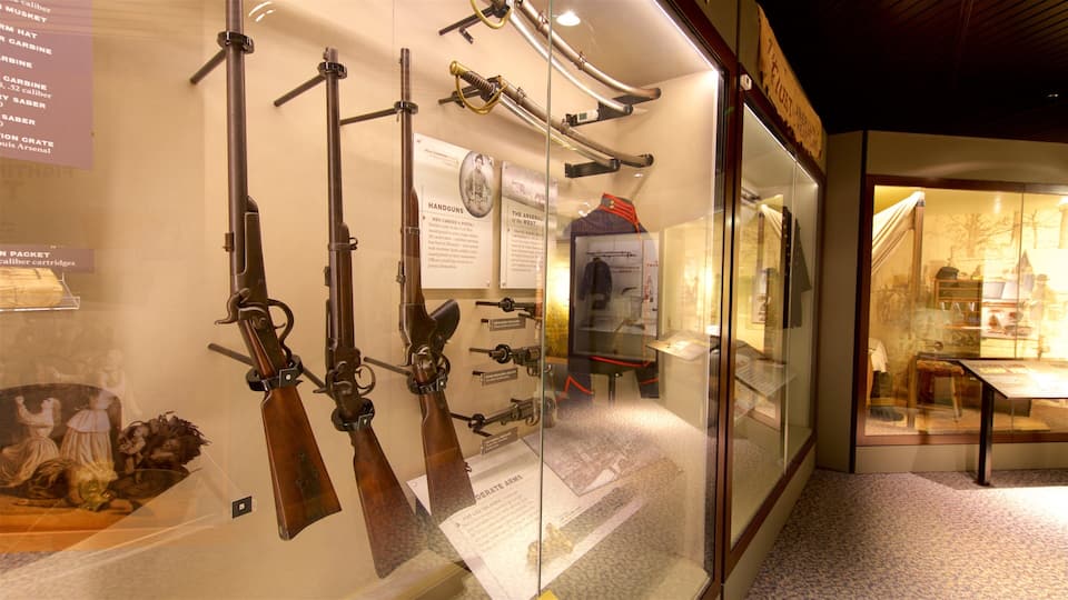 A museum exhibit with historical firearms on display.