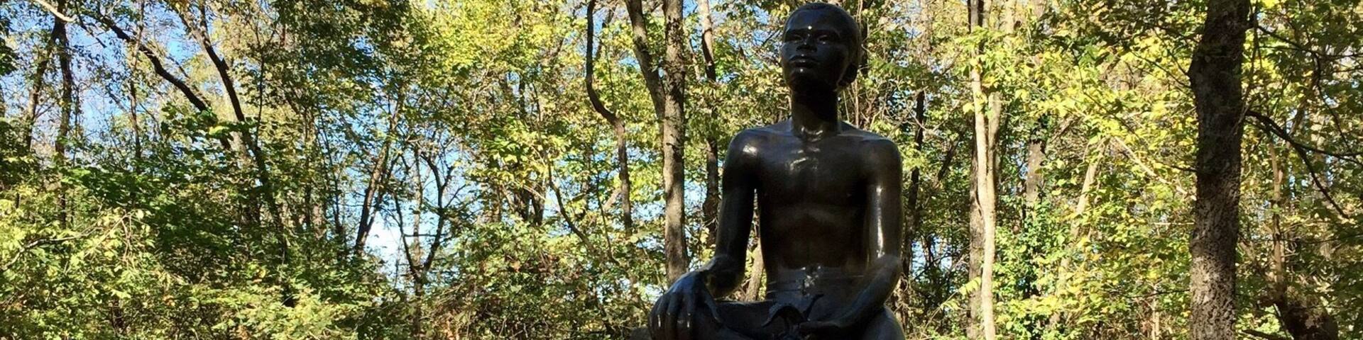 Statue of a young George Washington Carver located on the property he was born into slavery on. He would leave here in 1875 at age 11 to attend a 'colored' school. His thirst for education would continue throughout his life leading him to a teaching job at the Tuskegee institute. It's an inspirational story that is well documented and explained at this National Monument.