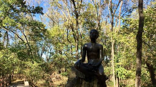 Statue of a young George Washington Carver located on the property he was born into slavery on. He would leave here in 1875 at age 11 to attend a 'colored' school. His thirst for education would continue throughout his life leading him to a teaching job at the Tuskegee institute. It's an inspirational story that is well documented and explained at this National Monument.