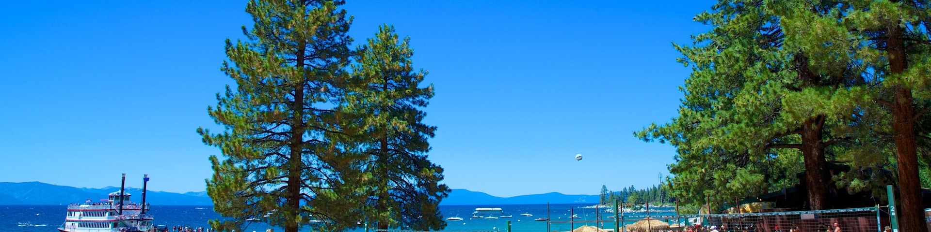 Zephyr Cove Beach showing a beach as well as a small group of people