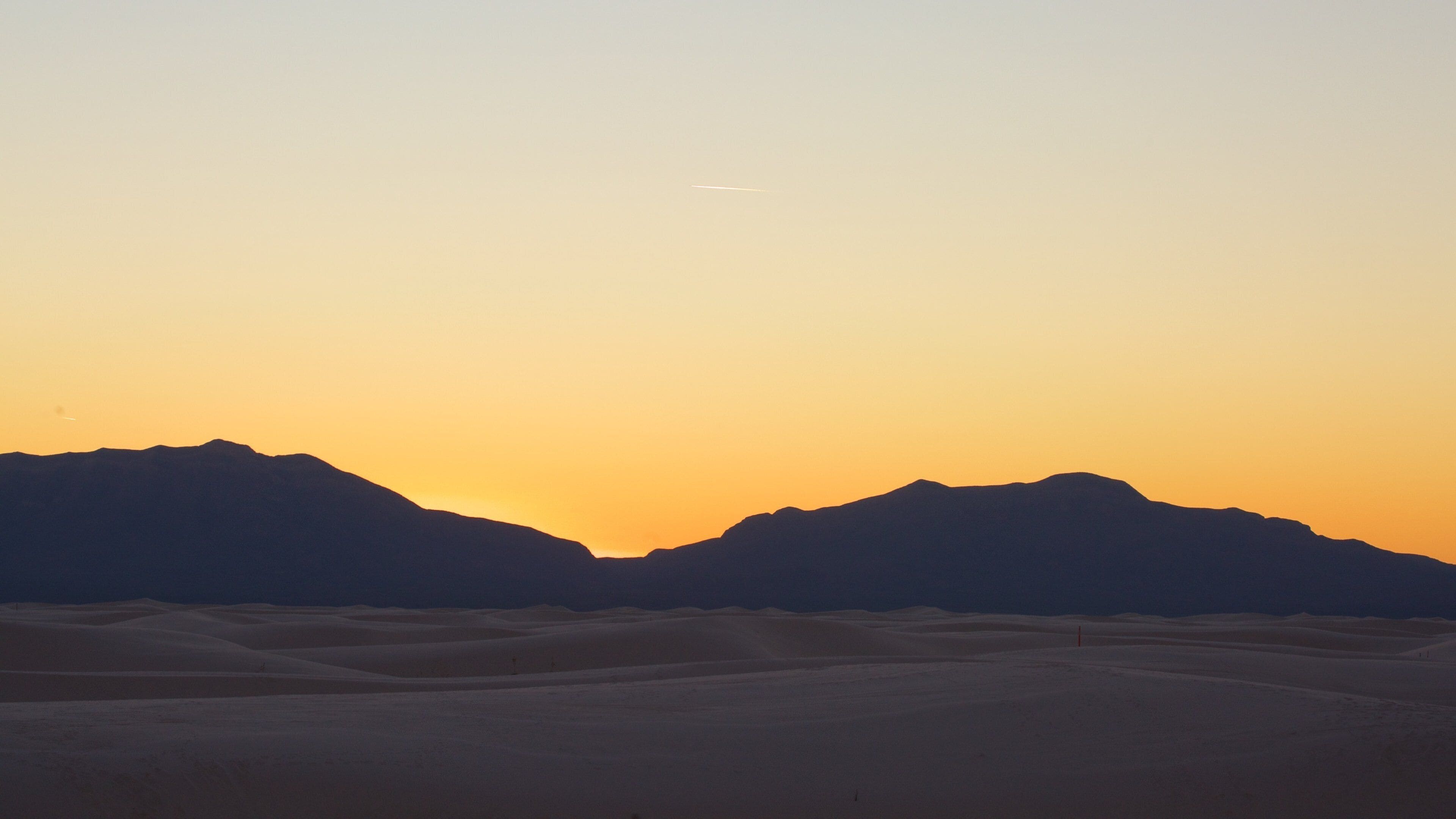 White Sands National Monument showing mountains and a sunset