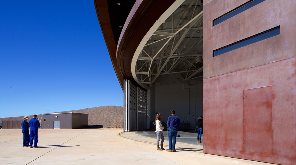 Spaceport America featuring industrial elements as well as a small group of people