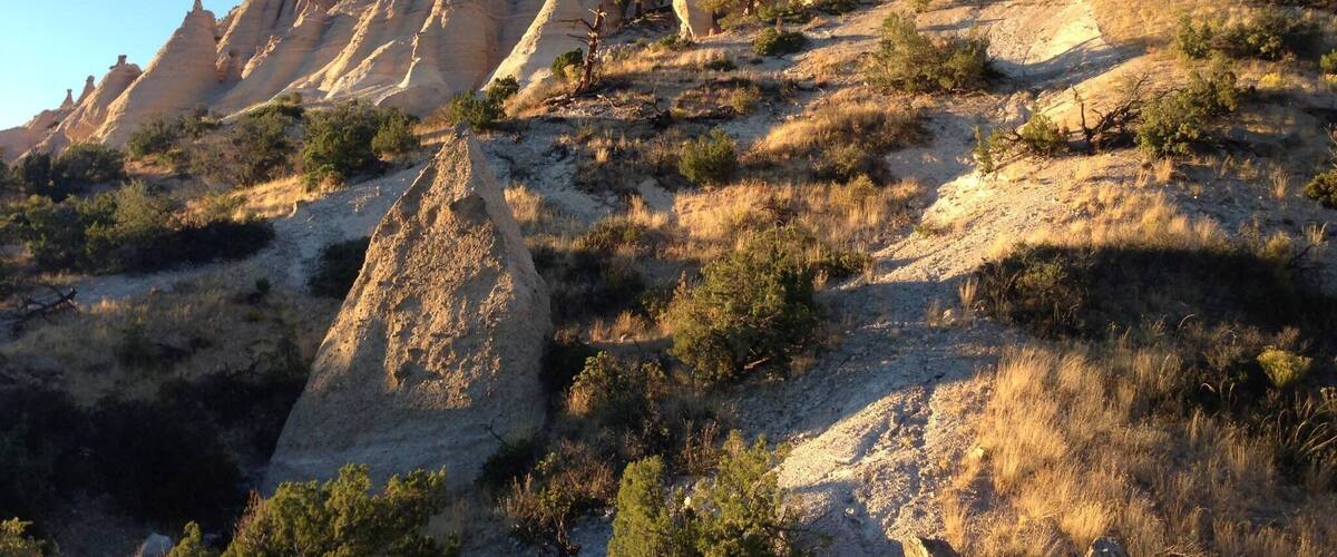 A rugged mountain landscape with prominent rock formations and sparse vegetation.