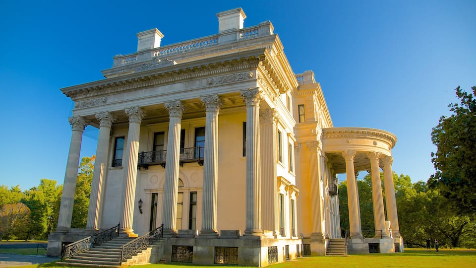 A neoclassical building with columns, a balcony, and a circular pavilion.