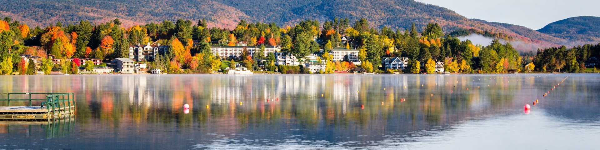 Beautiful Village of Lake Placid from a Foggy Mirror Lake in Autumn at Sunrise