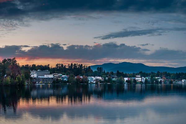 A panoramic view of the village of Lake Placid as seen from across Mirror Lake at sunset