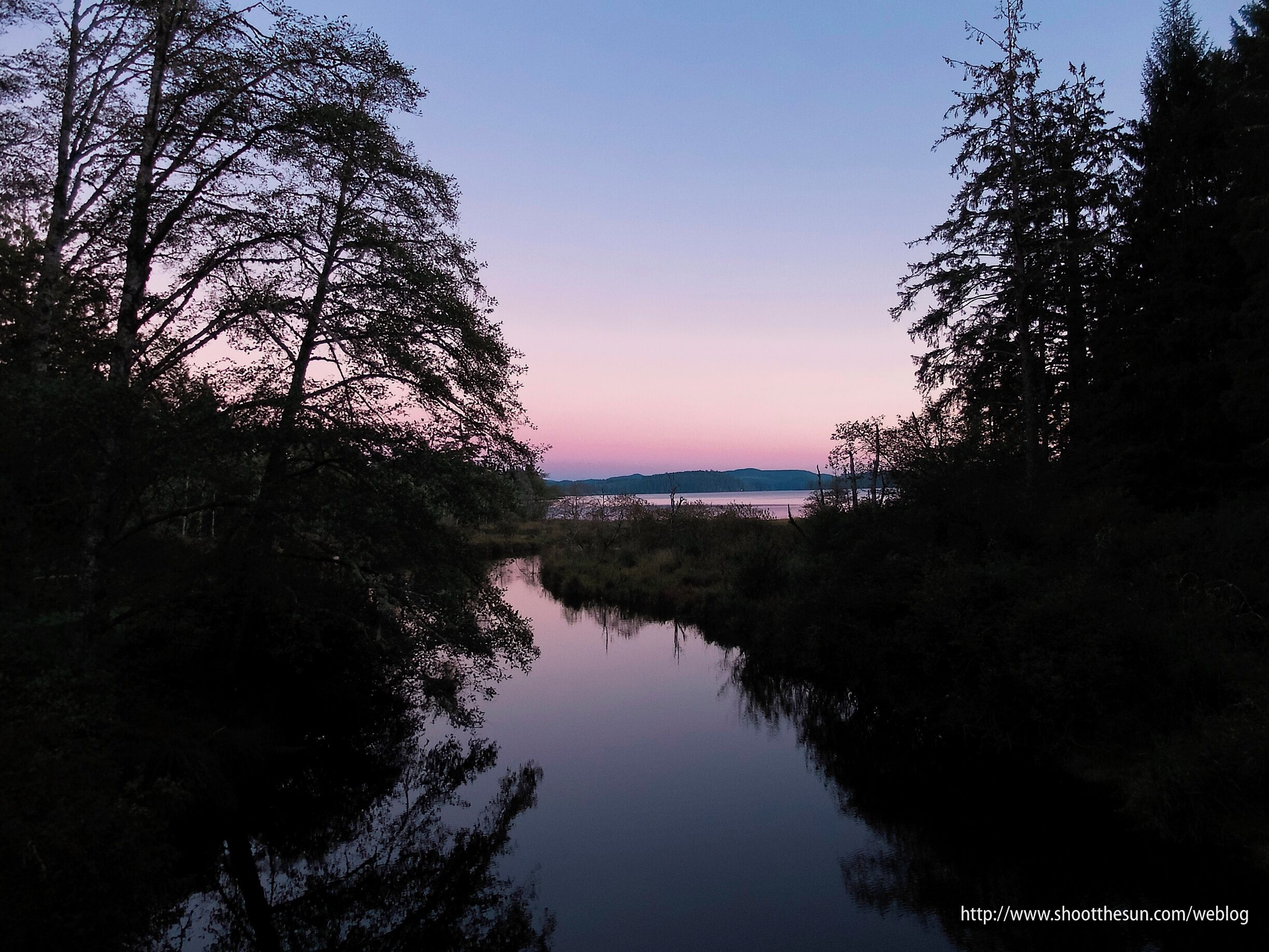 As promised, another sunset to finish off the day.
The trail that begins at Ozette Lake is billed as a 10.5 mile triangle which leads you down to the ocean and across a couple of miles of beach.
But, practically speaking, you need to find a way to navigate the surf unless you hit the beach at very low tide.  Our hike stretched out for about 12 miles, as we made serpentine patterns through the exposed rocks out and back to see all the sea stacks.
When we returned to the lake, the sun had all but rolled over the lip of the earth.  But it left a few colors dangling in the air, and Ozette Lake caught them all and tossed them back up like a smooth and silky sheet of glass.