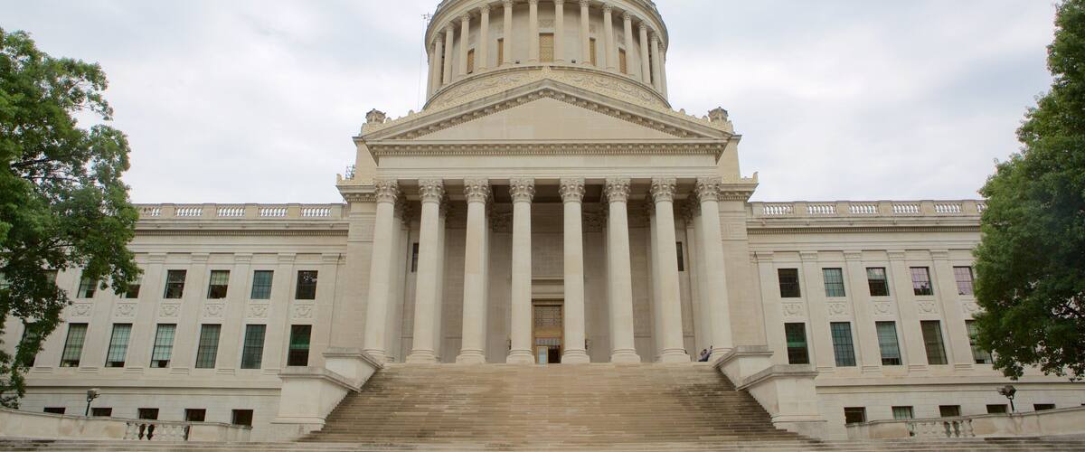 A large neoclassical building with a golden dome, wide steps leading up to the entrance, and symmetrical columns.