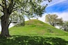 Moundsville, West virginia, just outside of Wheeling, is home to the Grave Creek Mound. This historic landmark burial mound was built by the Arena people.