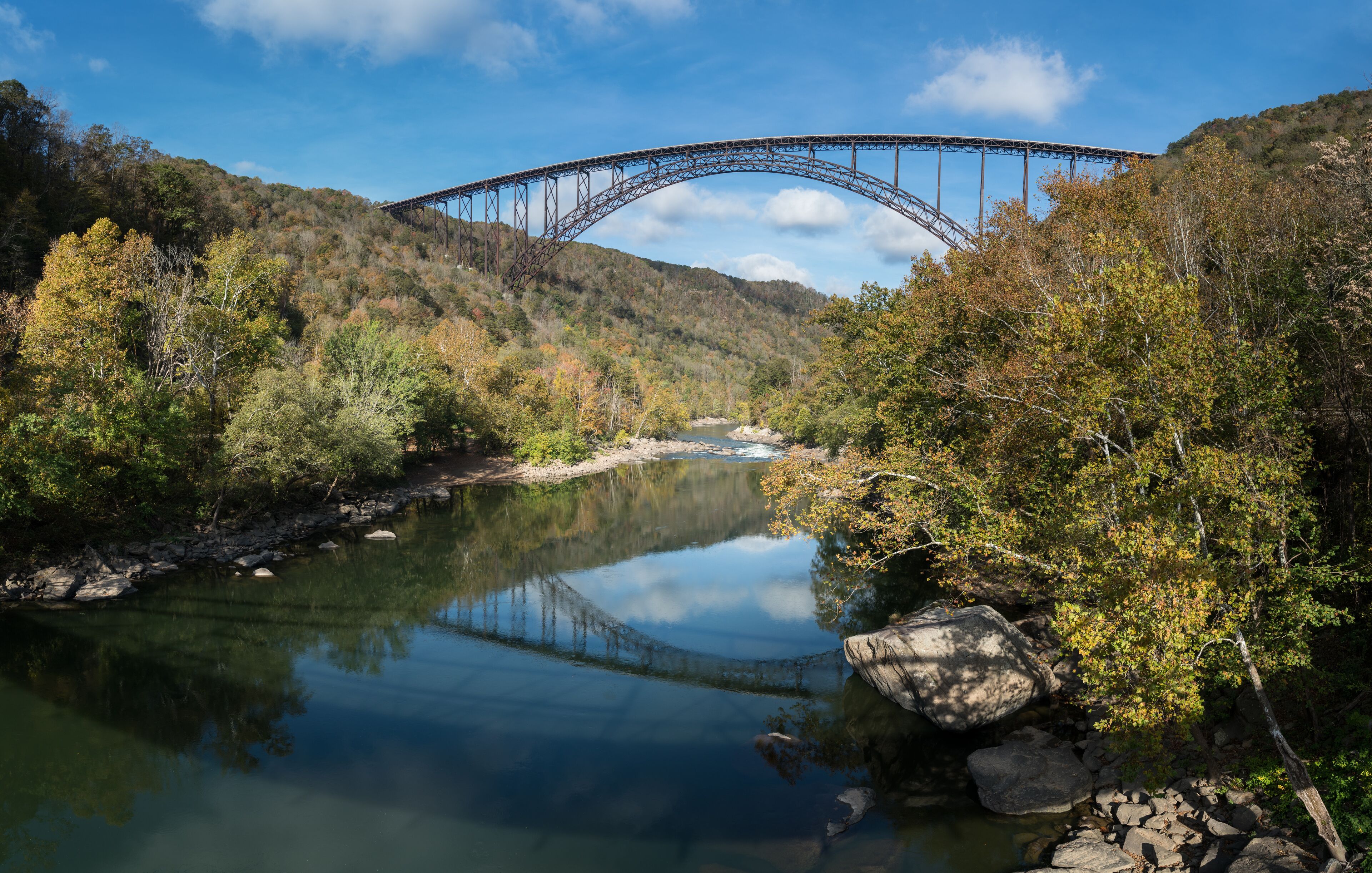 Reflections in the calm water under the high arched New River Gorge bridge in West Virginia; Shutterstock ID 510918895; Purchase Order: -