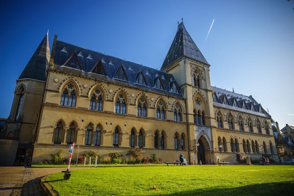 A historic building with a prominent tower and arched windows.