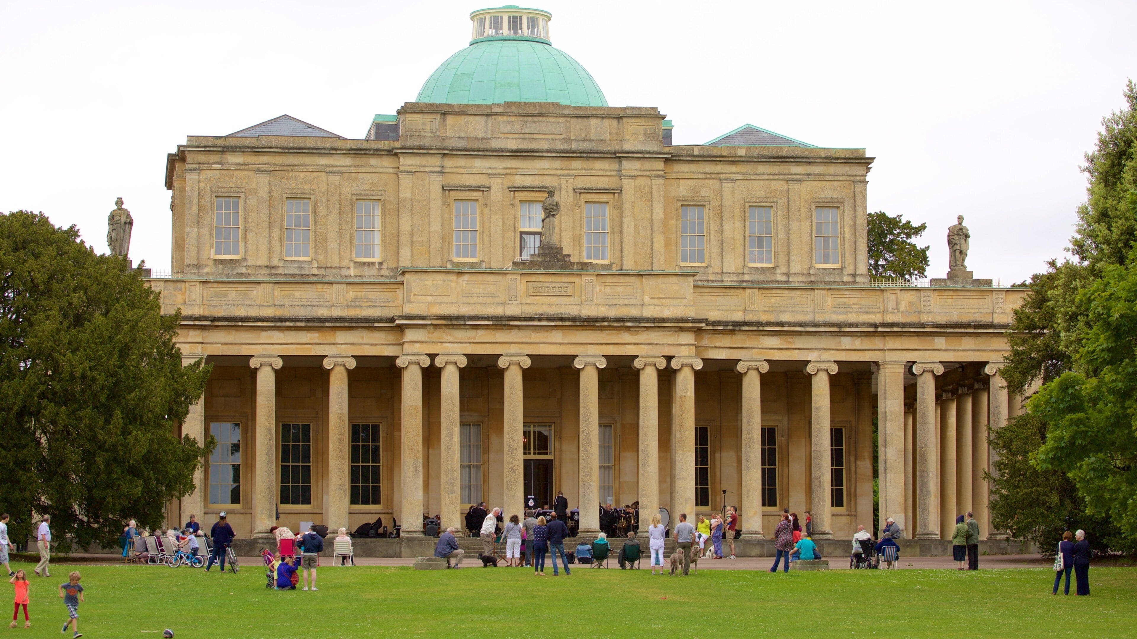 A large neoclassical building with a green dome and columns.