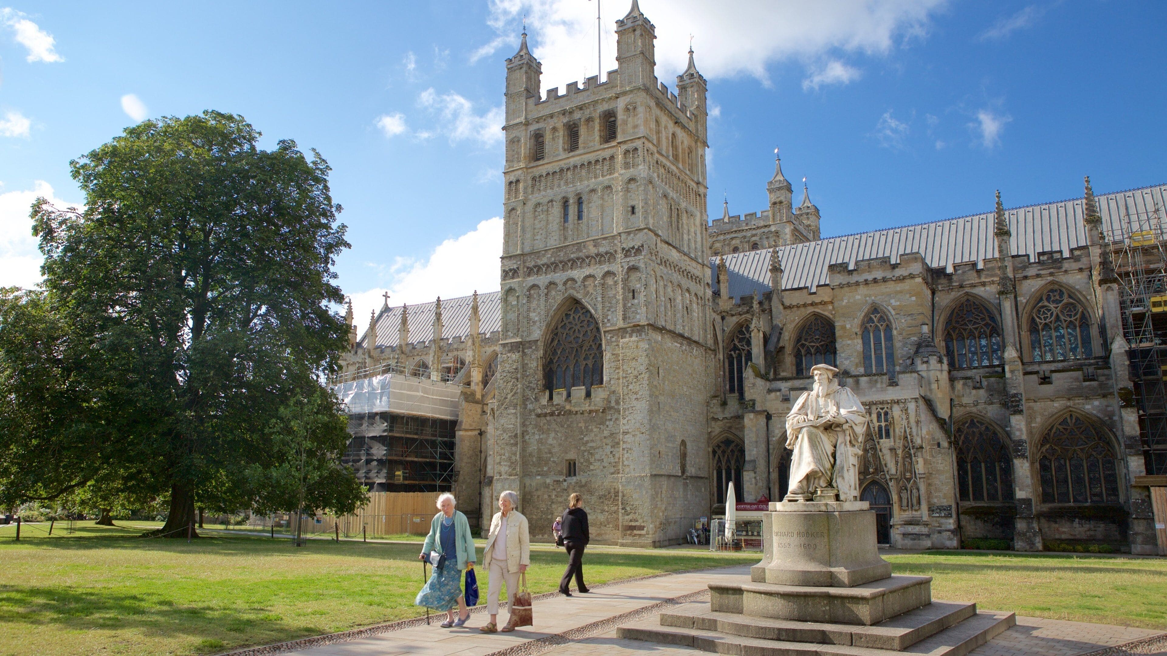 A historic building with a tall tower and intricate architecture.