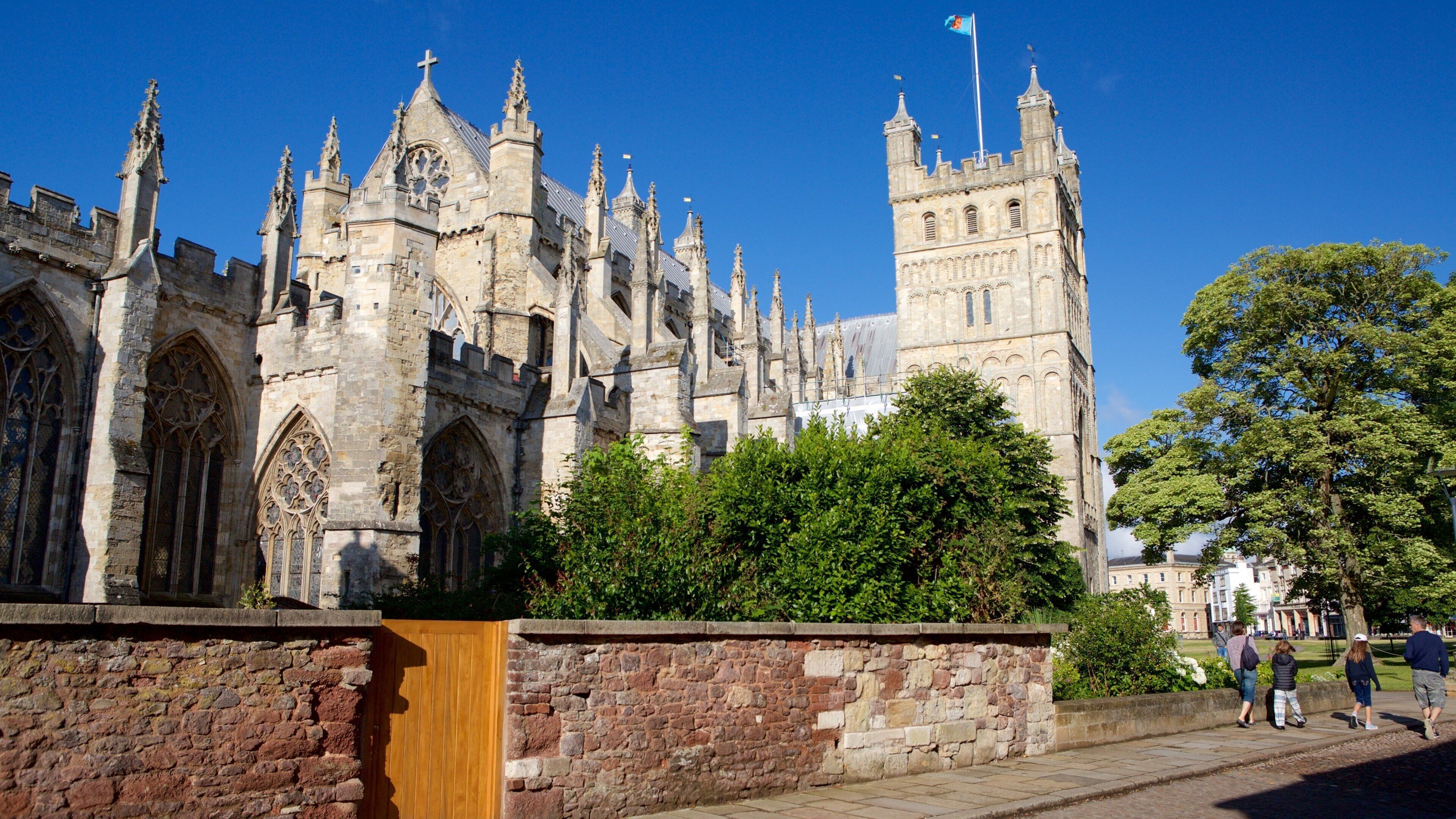 A historic building with intricate Gothic architecture, including pointed arches and a tall tower.