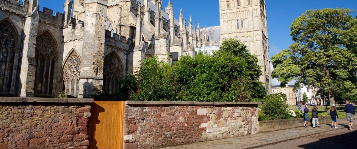 A historic building with intricate Gothic architecture, including pointed arches and a tall tower.