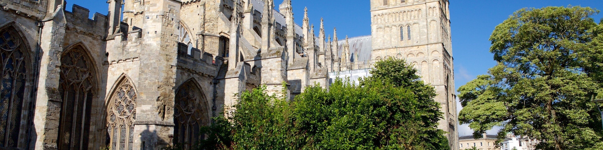 A historic building with intricate Gothic architecture, including pointed arches and a tall tower.