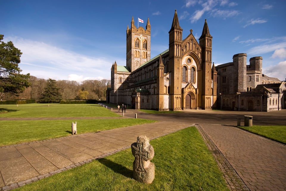 A historic building with a prominent tower and arched windows.