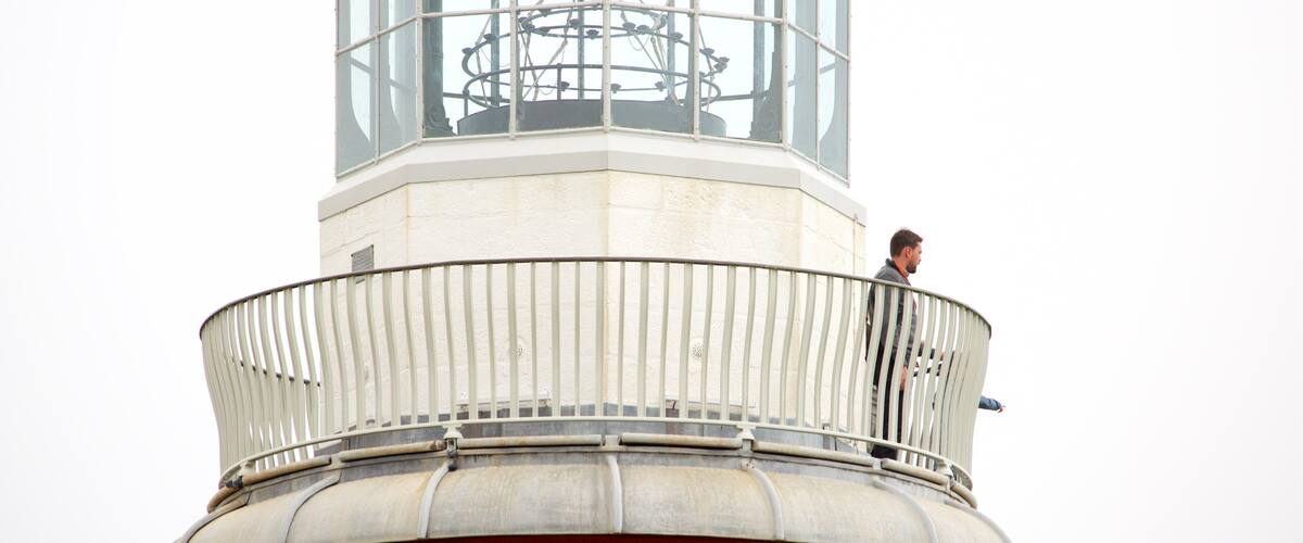 Smeatons Tower featuring a lighthouse as well as an individual male