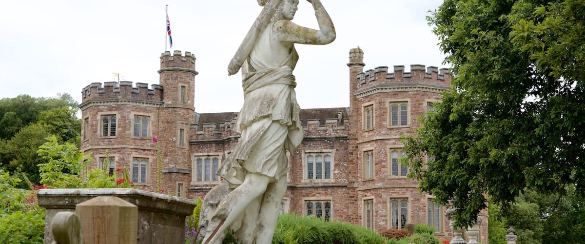 Mount Edgcumbe ofreciendo un castillo, un jardín y una estatua o escultura